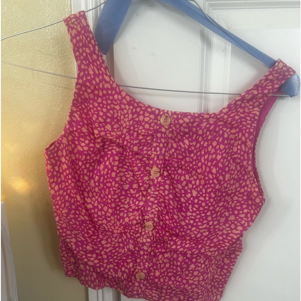 Pink shirt with white dots and buttons down the front